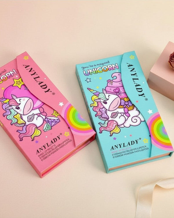 My Glam Room Anylady unicorn makeup palettes in pink and blue boxes with whimsical cartoon designs on a soft background