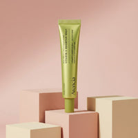 My Glam Room Arencia Vitamin C Booster Shot serum in a lime green tube displayed on geometric blocks.