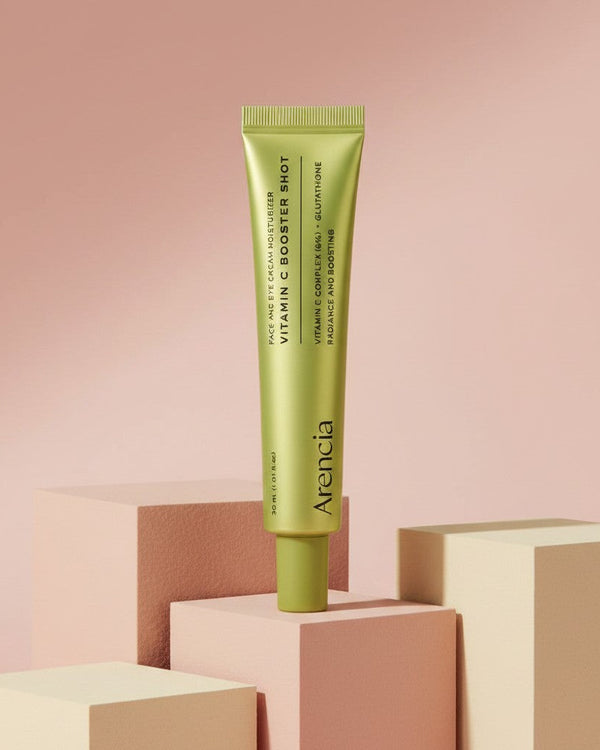 My Glam Room Arencia Vitamin C Booster Shot serum in a lime green tube displayed on geometric blocks.