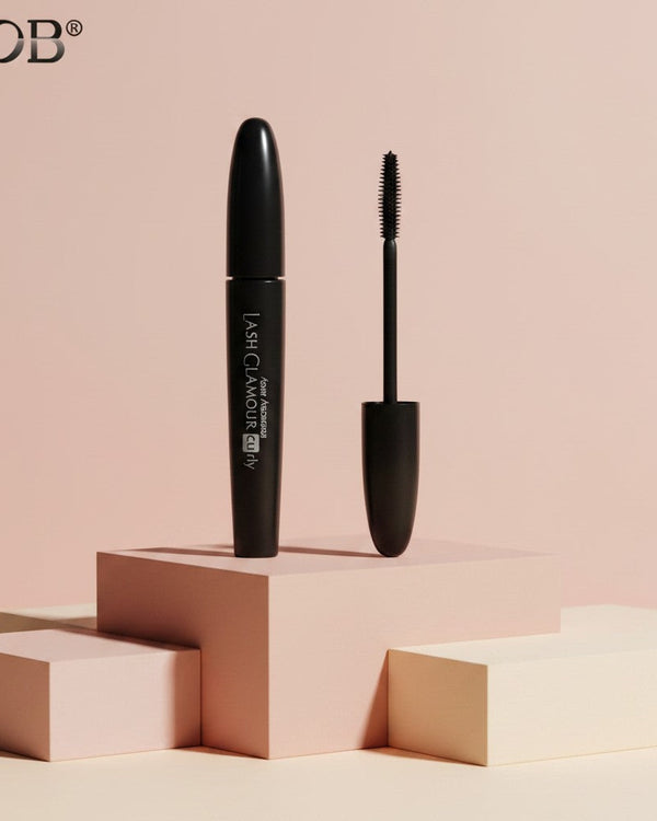 My Glam Room BOB 360 black dense mascara tube and applicator brush on a minimalist geometric display stand