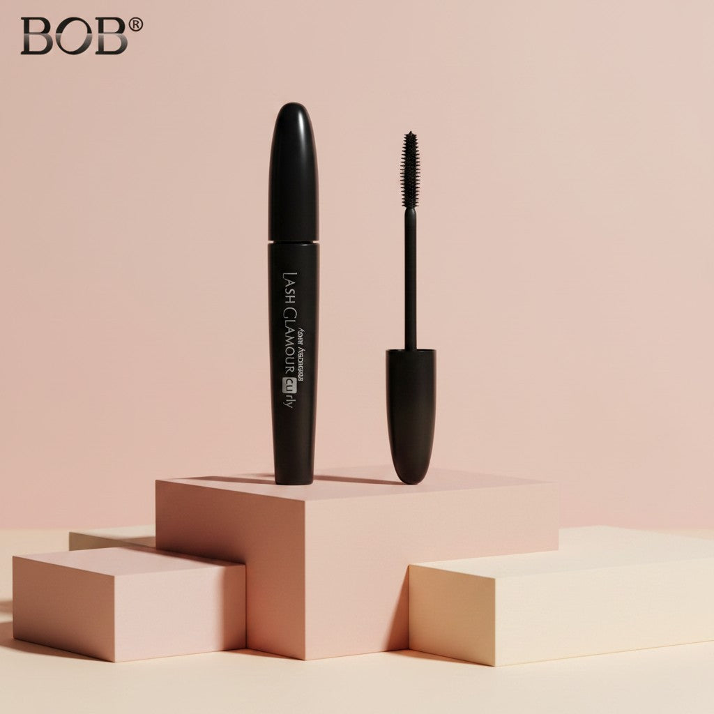 My Glam Room BOB 360 black dense mascara tube and applicator brush on a minimalist geometric display stand
