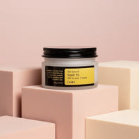 My Glam Room Cosrx Advanced Snail 92 All in One Cream in a frosted glass jar on pastel geometric blocks
