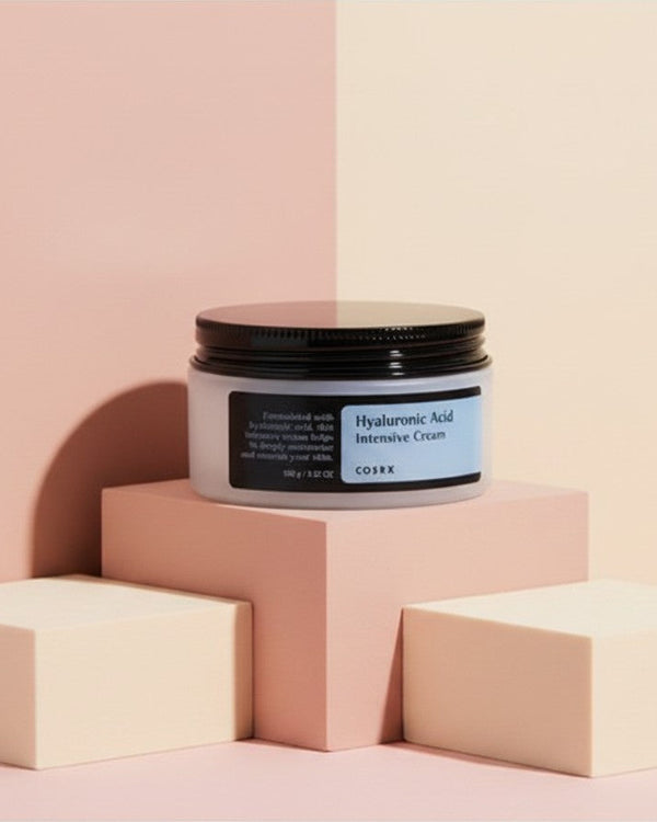 My Glam Room Cosrx Hyaluronic Acid Intensive Cream in a 100g jar displayed on geometric blocks against a pastel background