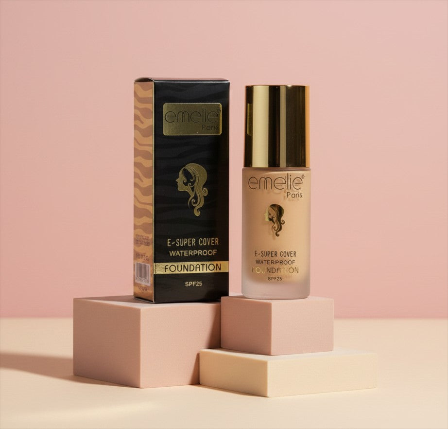 My Glam Room Emelie liquid foundation bottle with SPF 25 and matching black and gold packaging on pink blocks