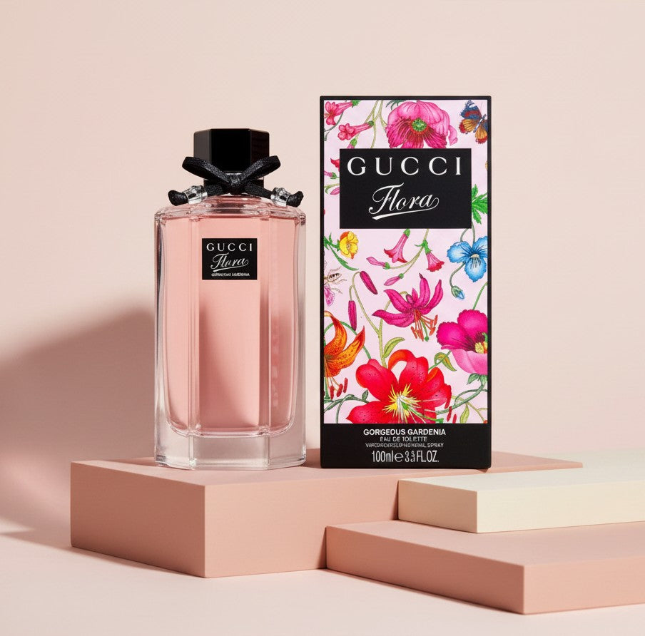 My Glam Room Gucci Flora Gorgeous Gardenia 100ml perfume bottle with black bow and floral box on pink display blocks
