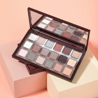 My Glam Room Hudamoji icy nude eyeshadow palette featuring 18 shimmer and matte neutral shades in a dark brown case.
