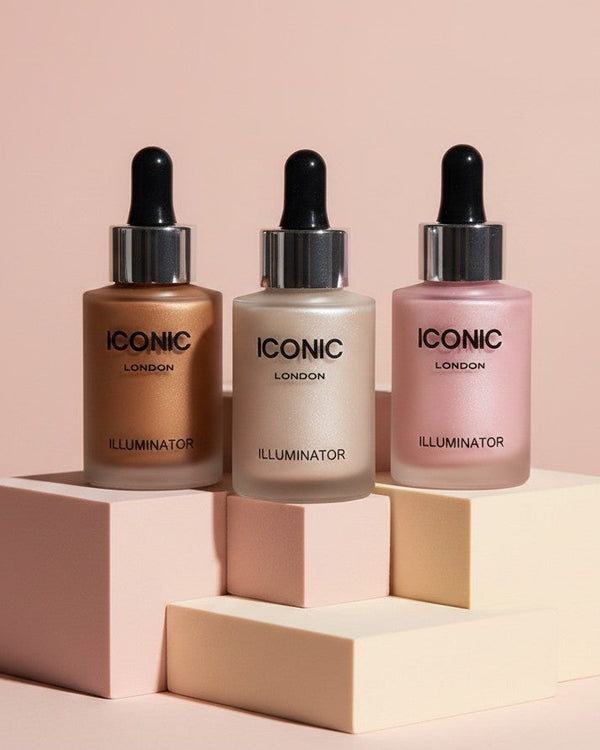 My Glam Room Iconic liquid highlighter bottles in bronze, champagne, and pink shades on geometric display blocks