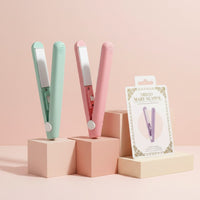 My Glam Room mini hair straighteners in pastel green and pink displayed on geometric blocks with product packaging