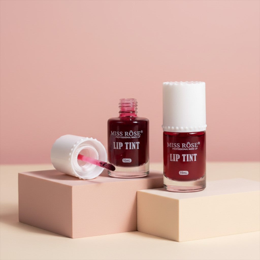 My Glam Room Miss Rose deep red lip and cheek tint in glass bottles with white caps on beige display blocks