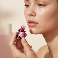 My Glam Room model applying Benefit Tint rose-colored liquid lip and cheek stain for a natural flush