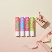 My Glam Room essence juicy bomb lip butter balm collection in four vibrant shades with decorative ribbon and flowers