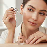 My Glam Room model applying Iconic London Illuminator liquid highlighter to cheekbone with a glass dropper