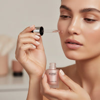 My Glam Room Iconic liquid Illuminator shine being applied to a model's cheek with a dropper for a radiant glow