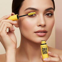 My Glam Room model applying Maybelline New York Volum’ Express Colossal Mascara with a bright yellow wand
