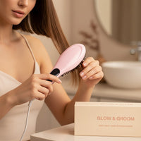 My Glam Room fast hair straightener brush in pastel pink being used by a woman to smooth her brown hair
