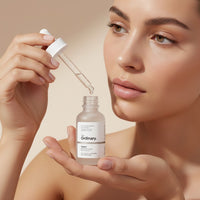 My Glam Room The Ordinary Buffet serum in a glass dropper bottle being applied by a woman with natural makeup