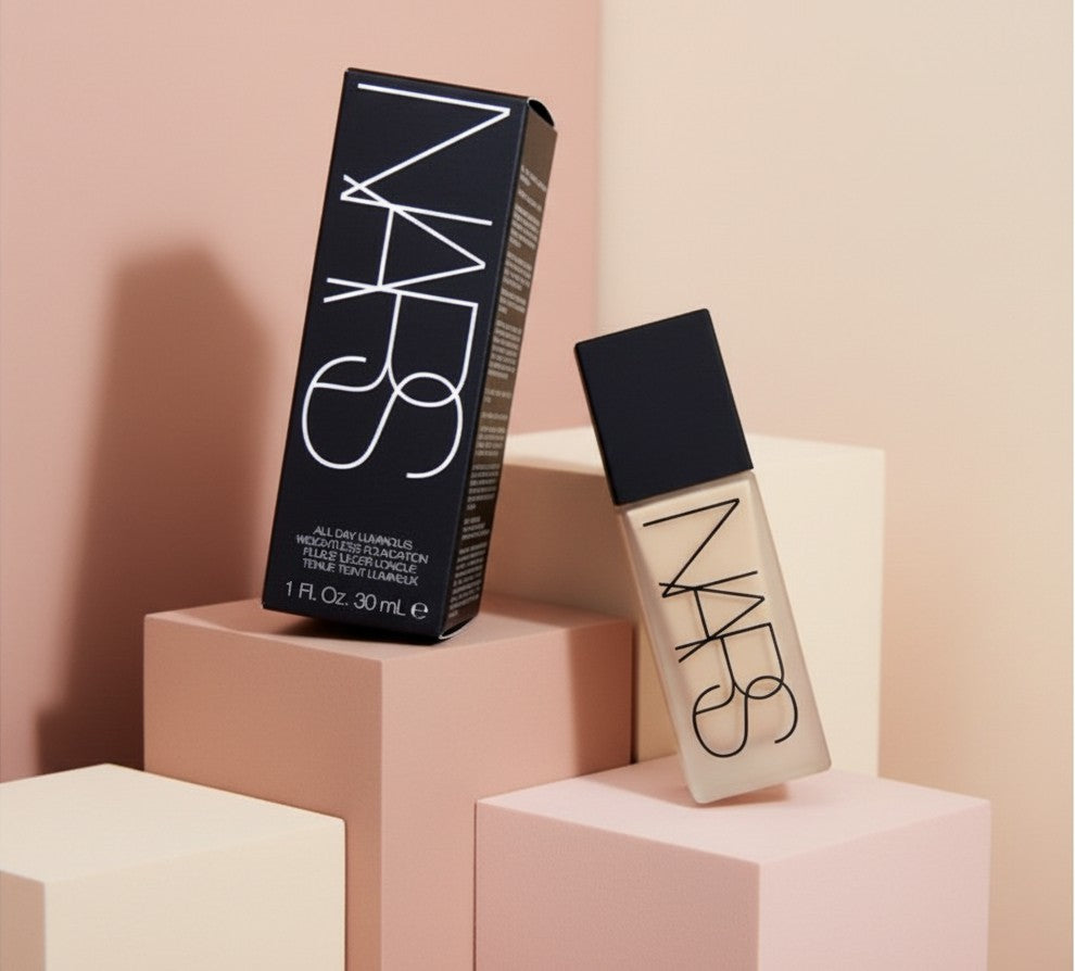 My Glam Room Nars All Day Luminous Foundation bottle and black box packaging on geometric pastel display blocks