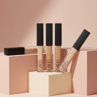 My Glam Room Nars liquid concealer tubes in various shades arranged on minimalist geometric blocks
