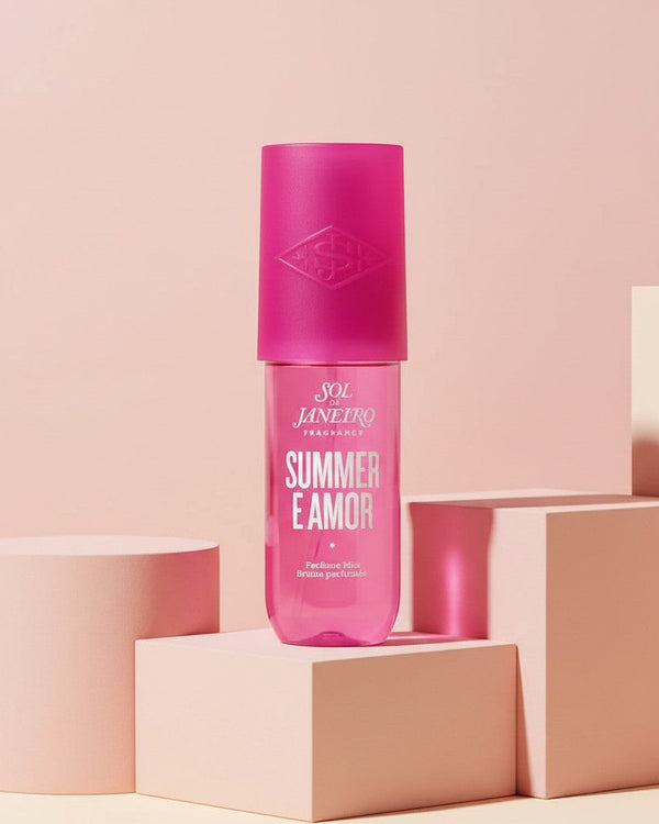 My Glam Room Sol De Janeiro SUMMER E Amor perfume mist in a bright pink bottle displayed on geometric pedestals