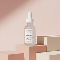 The Ordinary Buffet serum bottle from My Glam Room displayed on minimalist pastel geometric blocks.