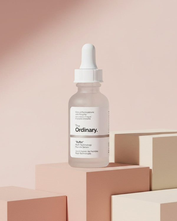 The Ordinary Buffet serum bottle from My Glam Room displayed on minimalist pastel geometric blocks.