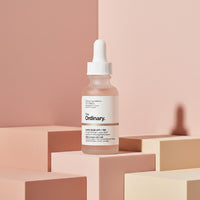 The Ordinary Lactic Acid 10% + HA exfoliating serum bottle on pink geometric blocks from My Glam Room