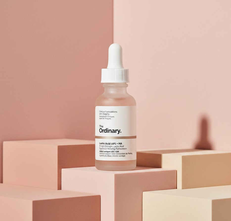 The Ordinary Lactic Acid 10% + HA exfoliating serum bottle on pink geometric blocks from My Glam Room