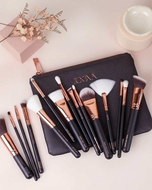 My Glam Room 15-piece Zoeva makeup brush set with black handles, rose gold ferrules, and a matching black clutch bag.