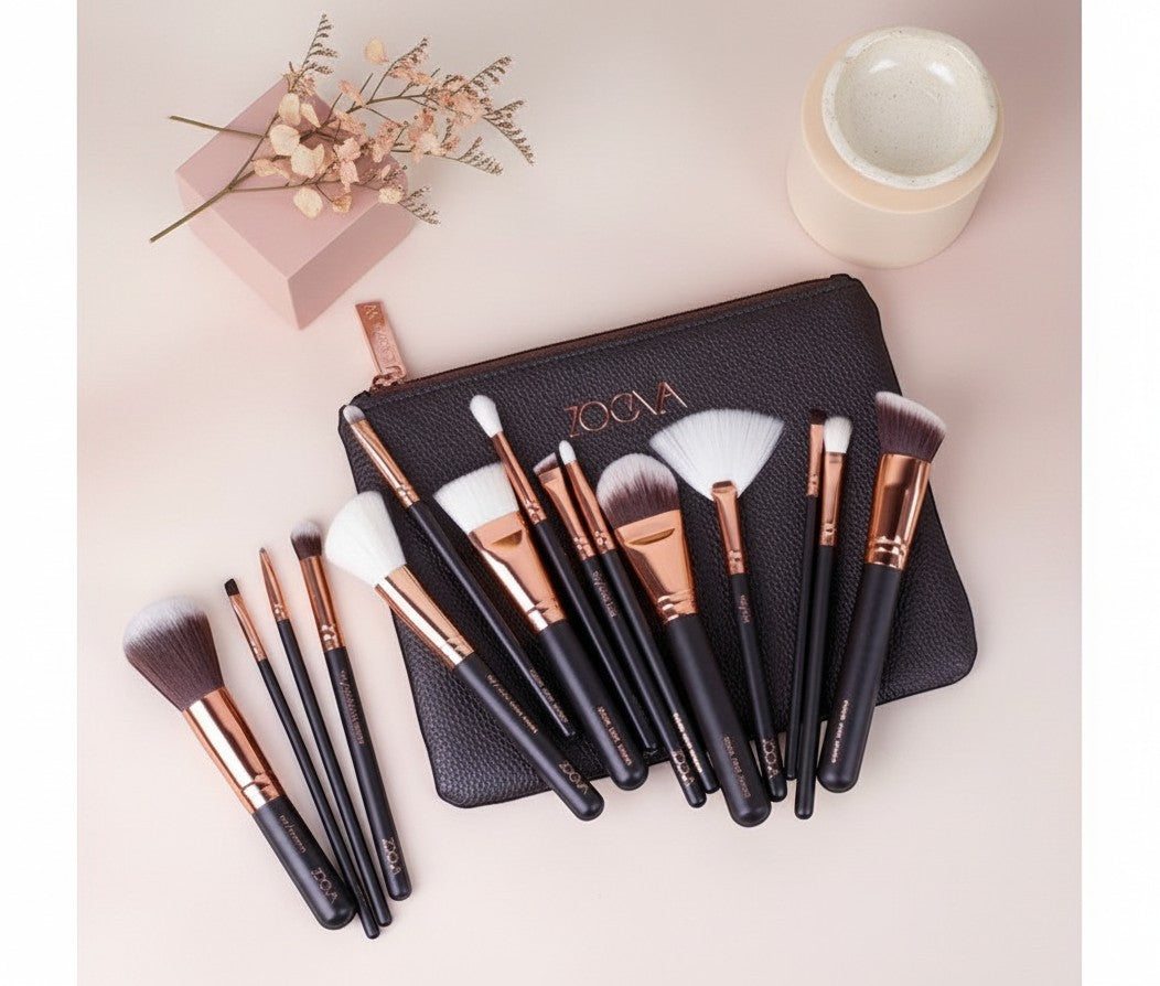 My Glam Room 15-piece Zoeva makeup brush set with black handles, rose gold ferrules, and a matching black clutch bag.
